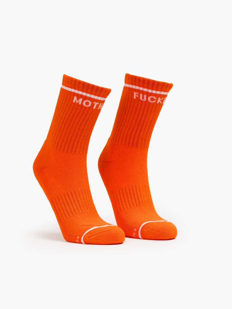 Side flat view of a vintage-inspired tube socks in bright orange and bold lettering in white.