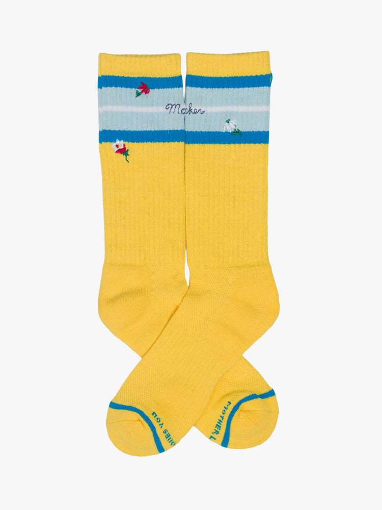 Flats view of extra-tall tube socks with an explicit message from MOTHER. Shown here in yellow with blue stripes and text across the top