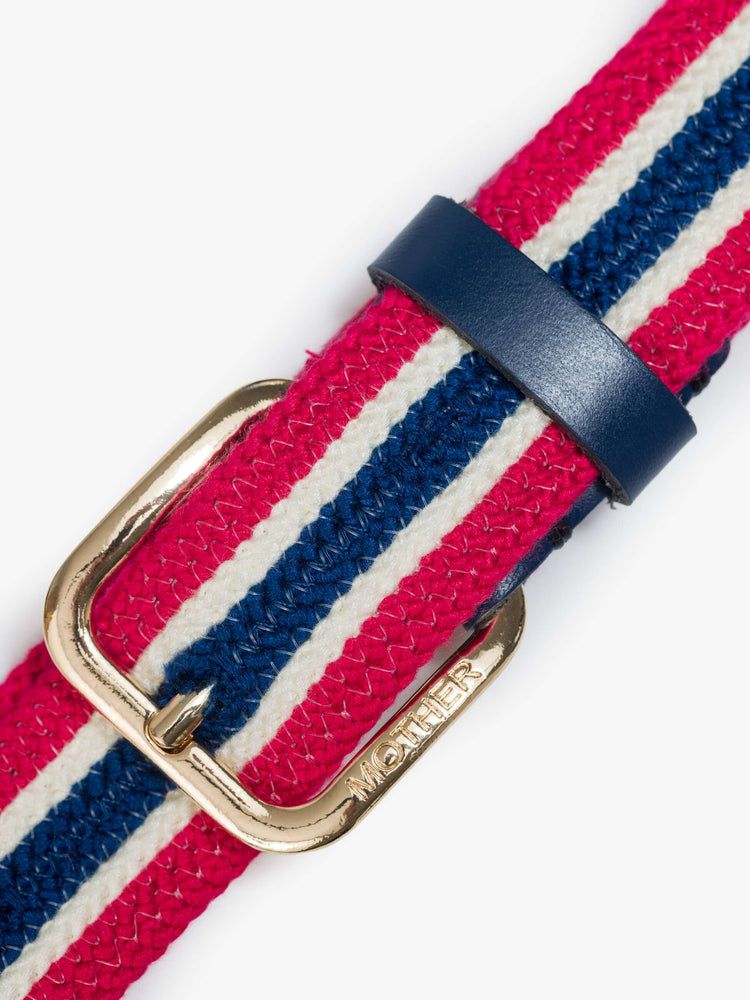 Close up view of a belt in shiny gold-colored buckle and vintage vibe in red, white and navy stripes.
