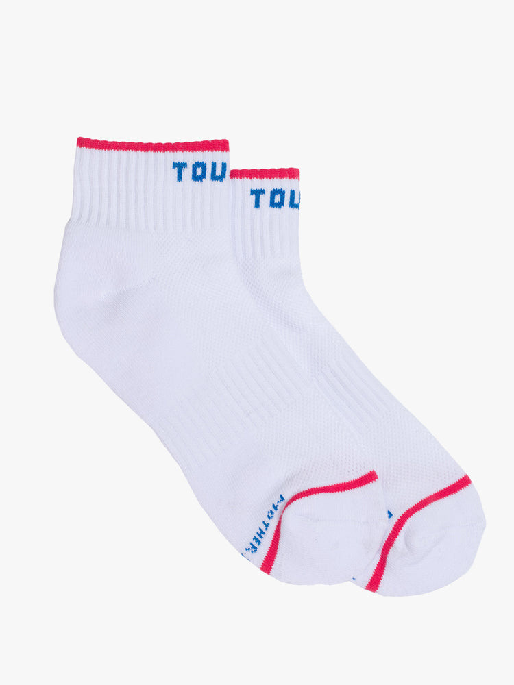 Side flat view of ankle length tube socks in oatmeal with navy text and red details.