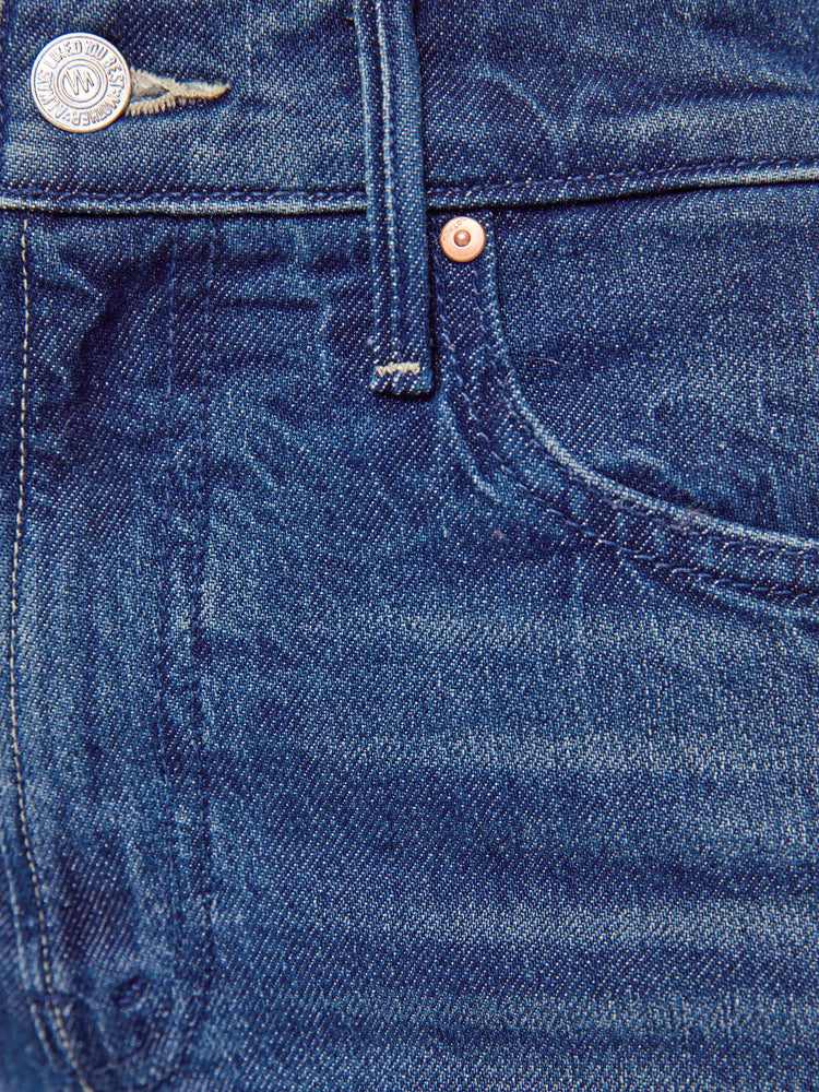 Swatch view of a petite woman in mid blue high-rise straight leg jean with a zip fly, long 30-inch inseam and a clean hem.