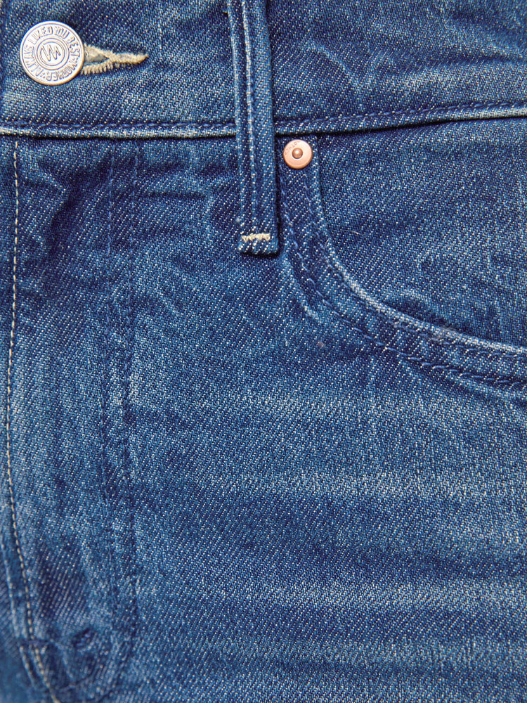 Swatch view of a petite woman in mid blue high-rise straight leg jean with a zip fly, long 30-inch inseam and a clean hem.