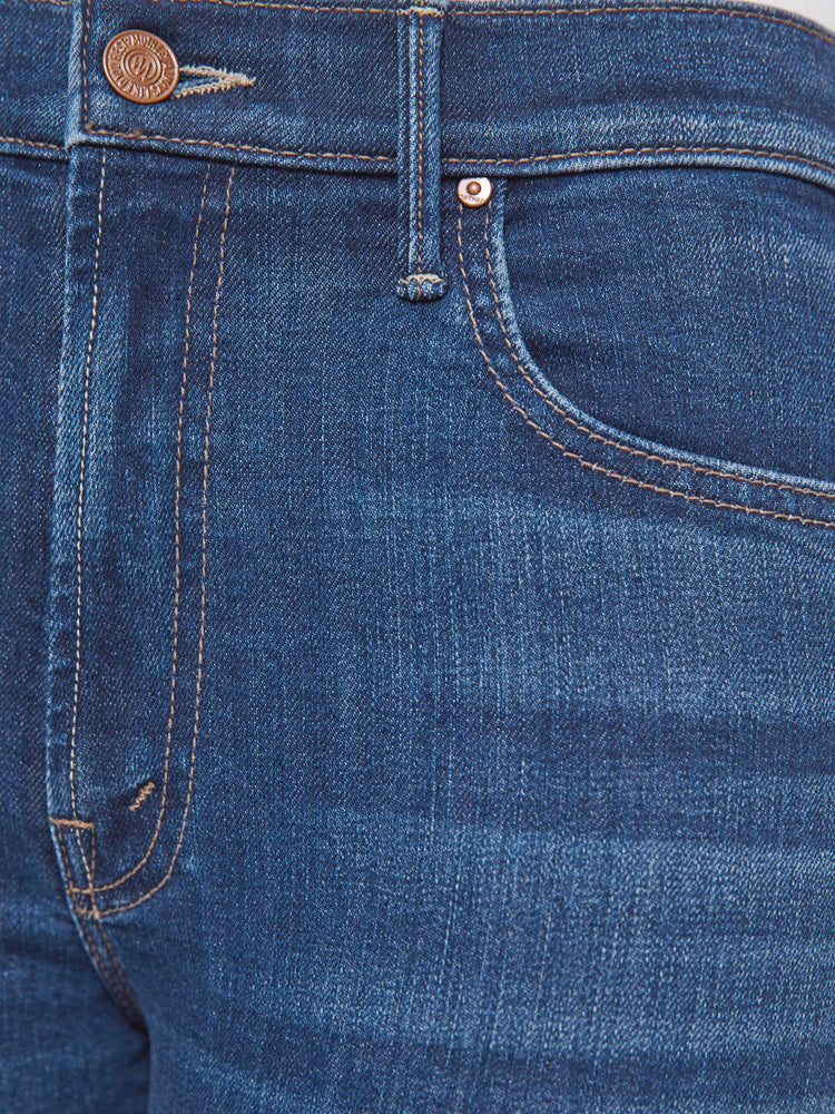 Swatch view of a petite woman in a med blue high-rise straight leg jean with a zip fly, 31.25-inch inseam and a clean hem.