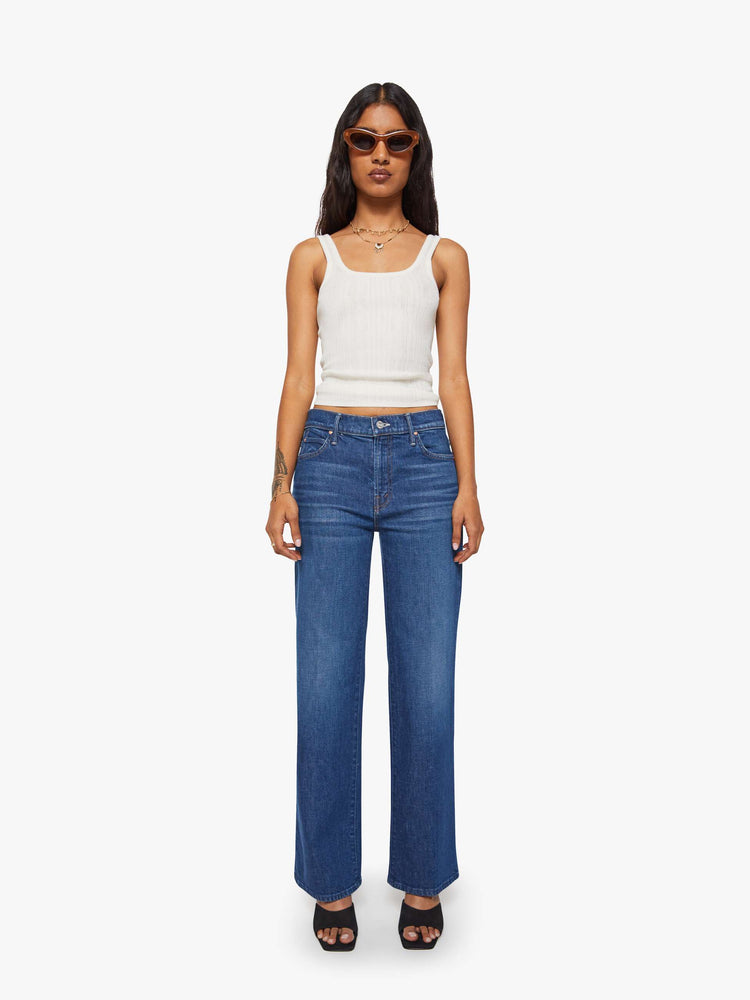 Front view of a petite woman in a high-rise straight leg jean with a zip fly, 29-inch inseam and a clean hem.