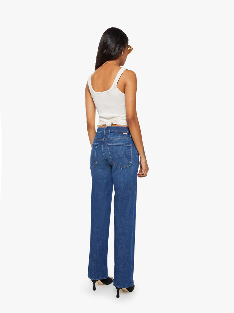 Back view of a petite woman in a high-rise straight leg jean with a zip fly, 29-inch inseam and a clean hem.