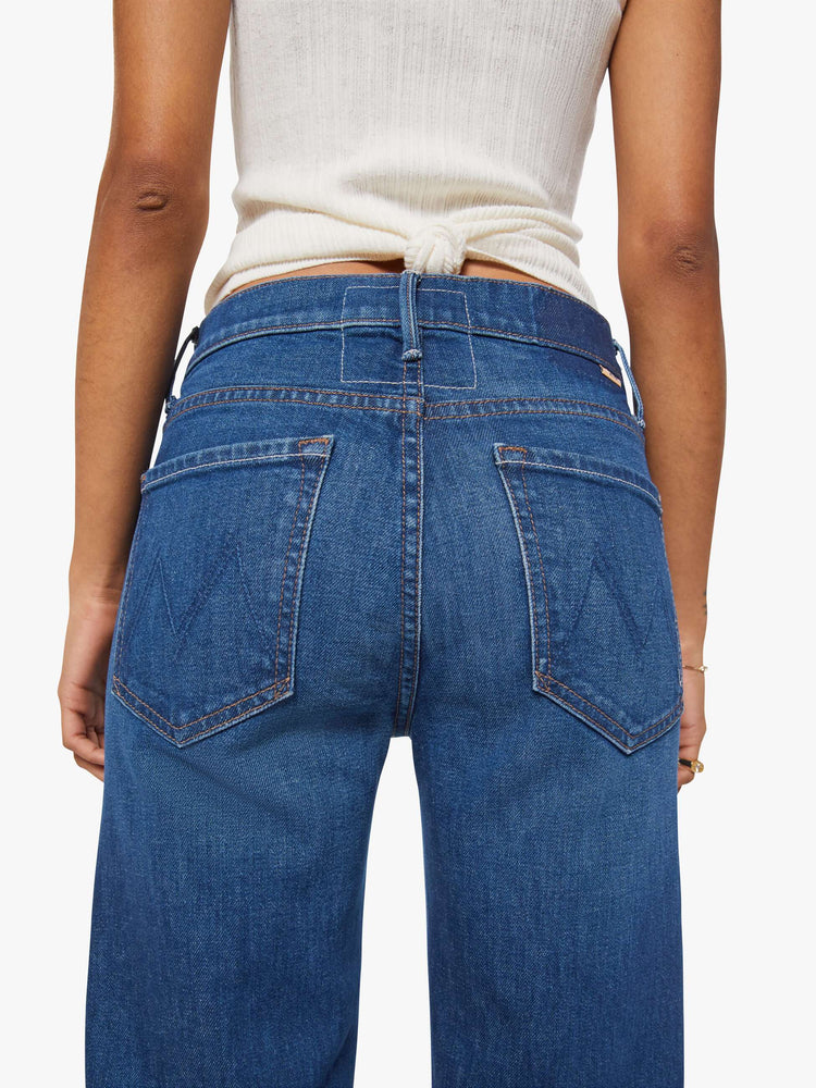 Close up view of a petite woman in a high-rise straight leg jean with a zip fly, 29-inch inseam and a clean hem.