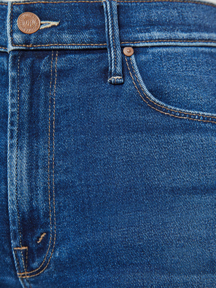 Swatch view of a mid blue high-rise flare with a long 31-inch inseam and a frayed hem.
