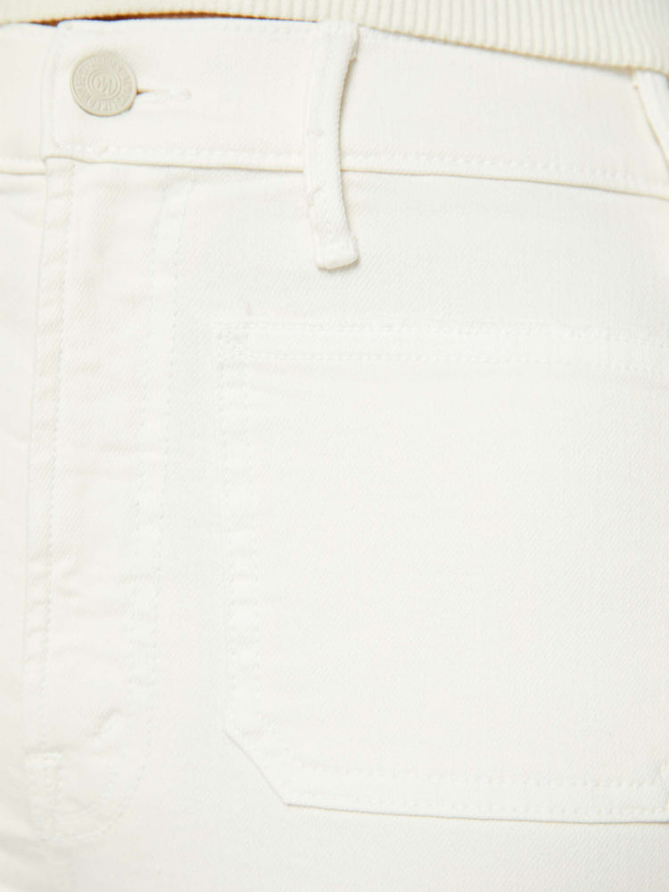 Swatch  view of a woman off white high-rise bootcut has a cropped inseam, patch pockets and a clean hem.