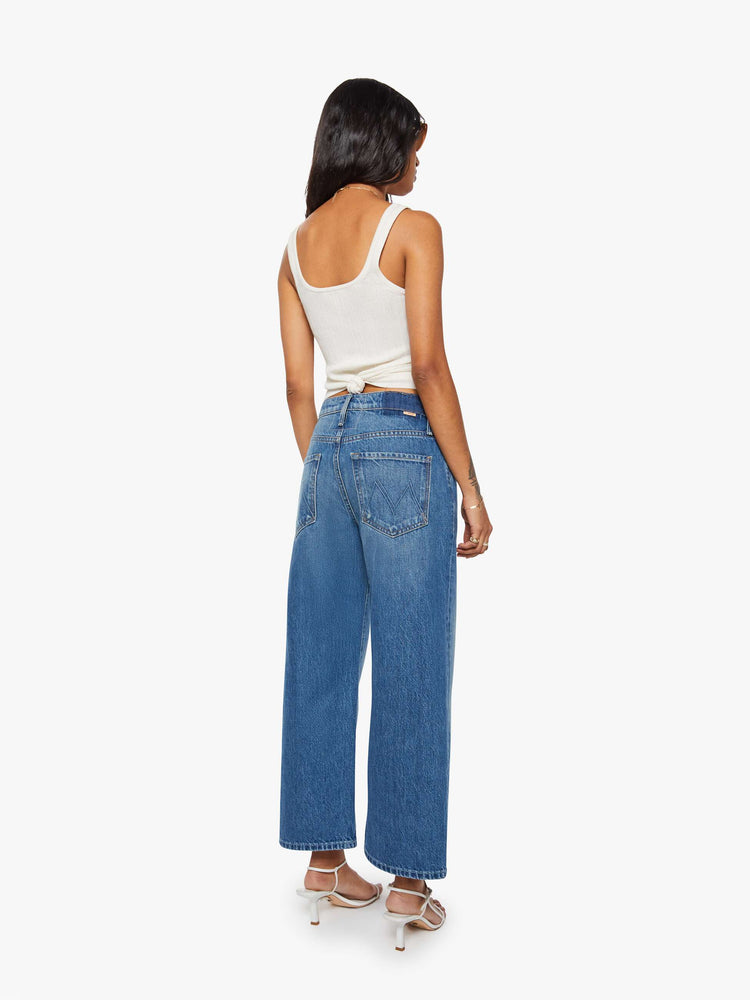 Back view of a woman in jeans designed to sit on the hips with a slouchy fit, a loose straight leg, button fly and a 26.25-inch inseam with a clean hem.