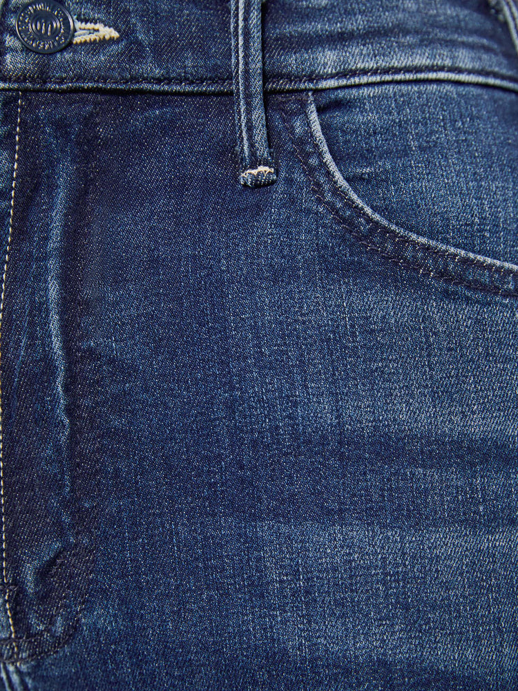 Close up view of a petite woman in a dark blue  wide leg jeans have a high rise, zip fly, long 29-inch inseam and a clean hem.