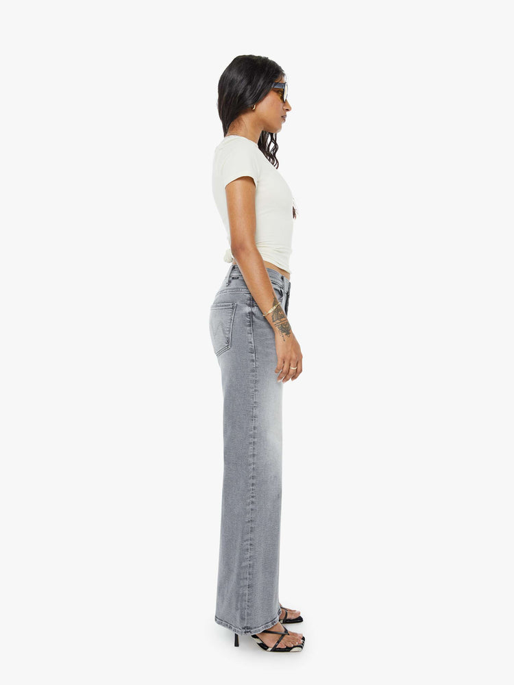 Side view of a petite woman in a gray wide leg pants with a zip fly, high rise, 28-inch inseam and a clean hem.