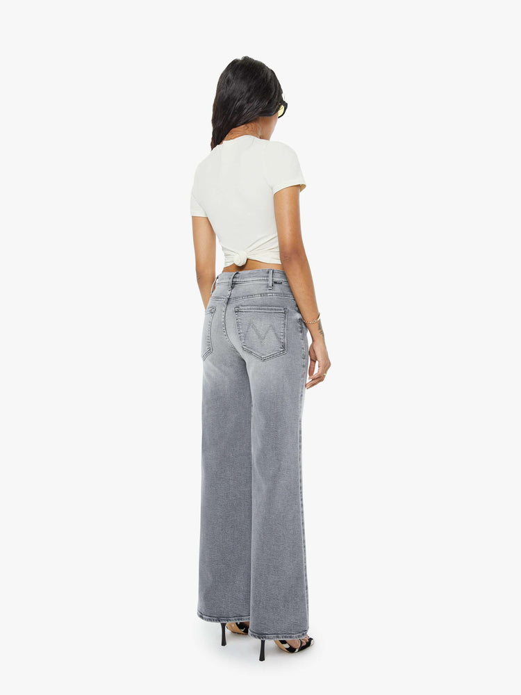 Back view of a petite woman in a gray wide leg pants with a zip fly, high rise, 28-inch inseam and a clean hem.