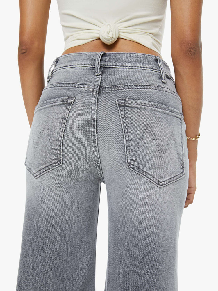 Back close up view of a petite woman in a gray wide leg pants with a zip fly, high rise, 28-inch inseam and a clean hem.