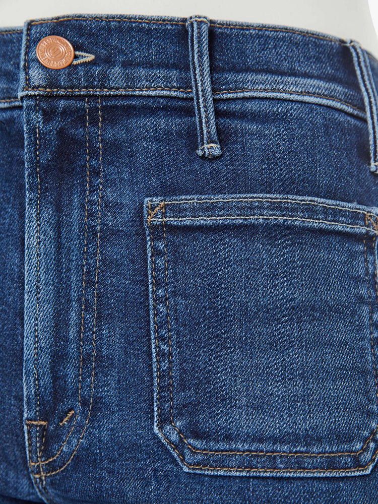 Swatch view of a petite woman in a  dark blue wide leg jeans with a high rise, zip fly, patch pockets, 28-inch inseam and a clean hem. 