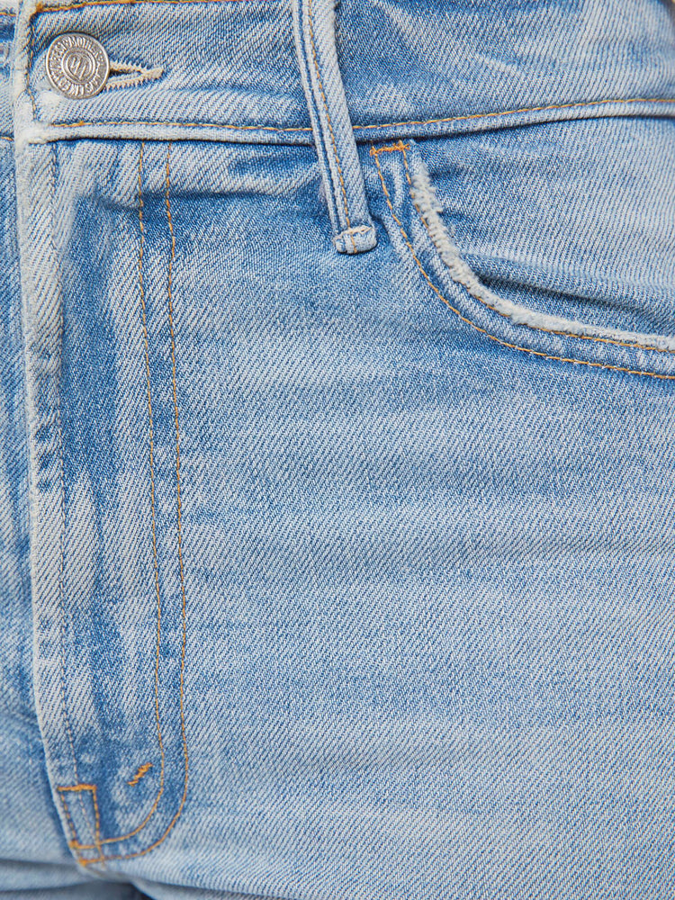 Swatch view of a petite woman in a light blue wide leg jeans with a high rise, zip fly, 32-inch inseam and a clean hem.