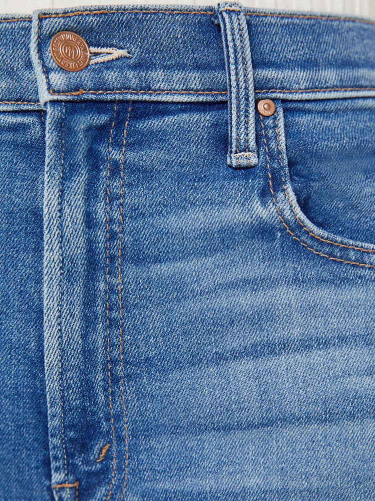 Swatch view of a petite woman high-waisted jeans with a wide straight leg, zip fly and clean ankle-length inseam in a mid blue wash.