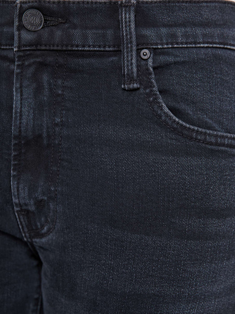 Swatch view of a petite woman in a dark denim mid-rise jean with a wide straight leg, zip fly and clean ankle-length inseam.