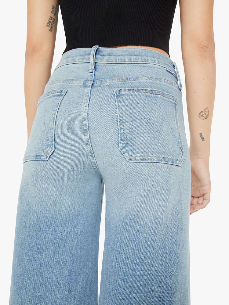 Back detail view of a womens light blue jean featuring a high rise, wide leg, and front patch pockets.