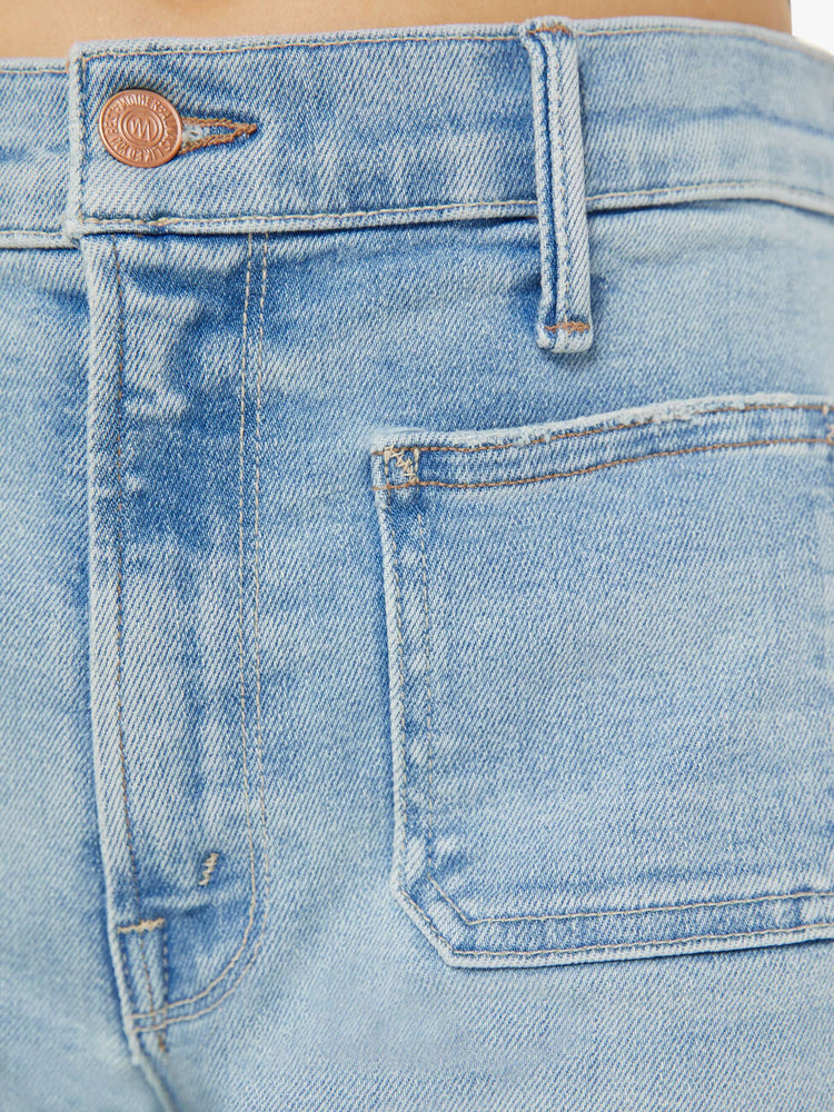 Front close up view of a womens light blue jean.