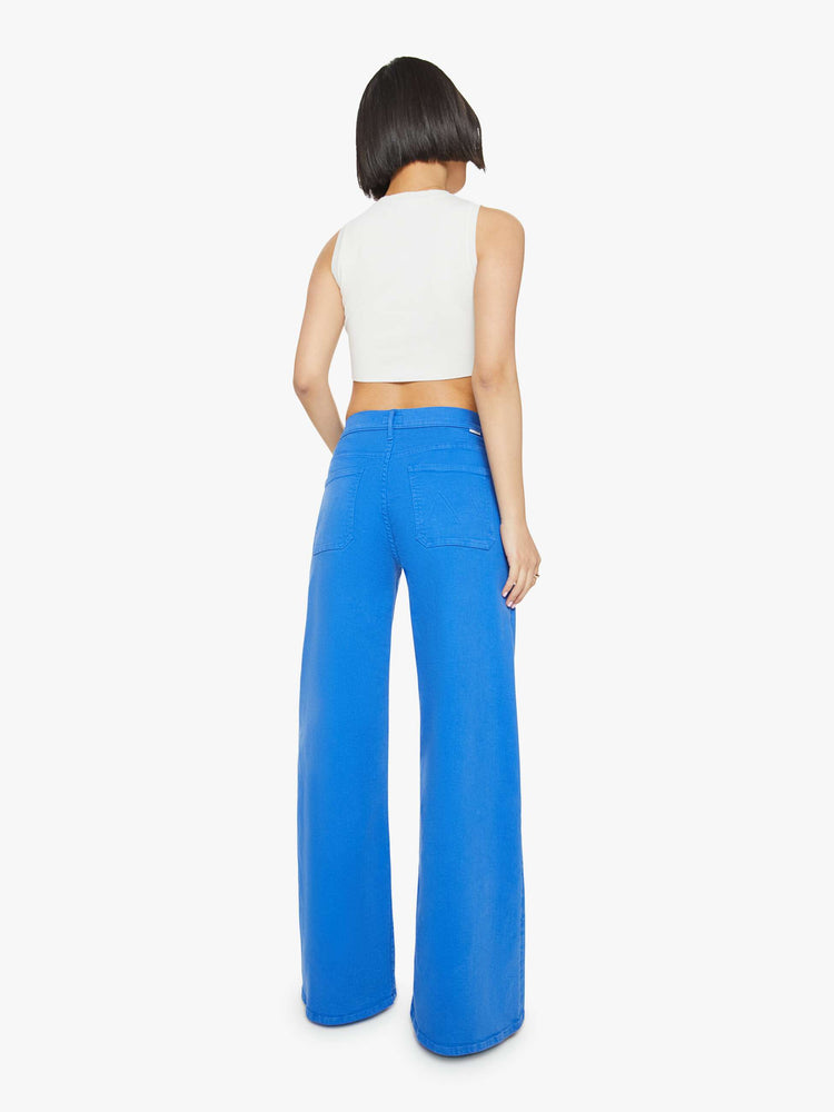 Back view of a woman in a bright sea blue wide leg pants with a high rise, patch pockets and a clean hem.