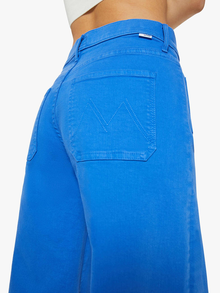 Back close up view of a woman in a bright sea blue wide leg pants with a high rise, patch pockets and a clean hem.