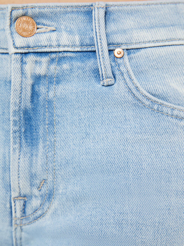Swatch view of a woman in light-blue high waisted bootcut jeans that have a clean hem with subtle whiskering and fading throughout.