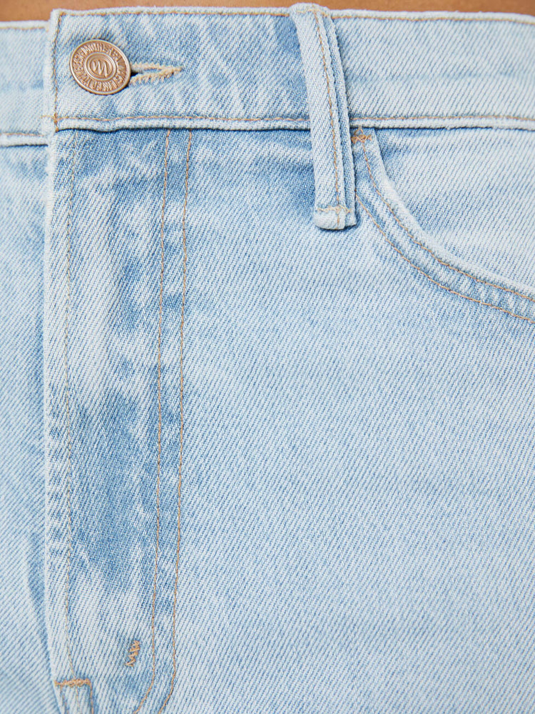 Swatch view of a petite woman in a light blue  wide leg pants with a zip fly, high rise, 29-inch inseam and a frayed hem. 