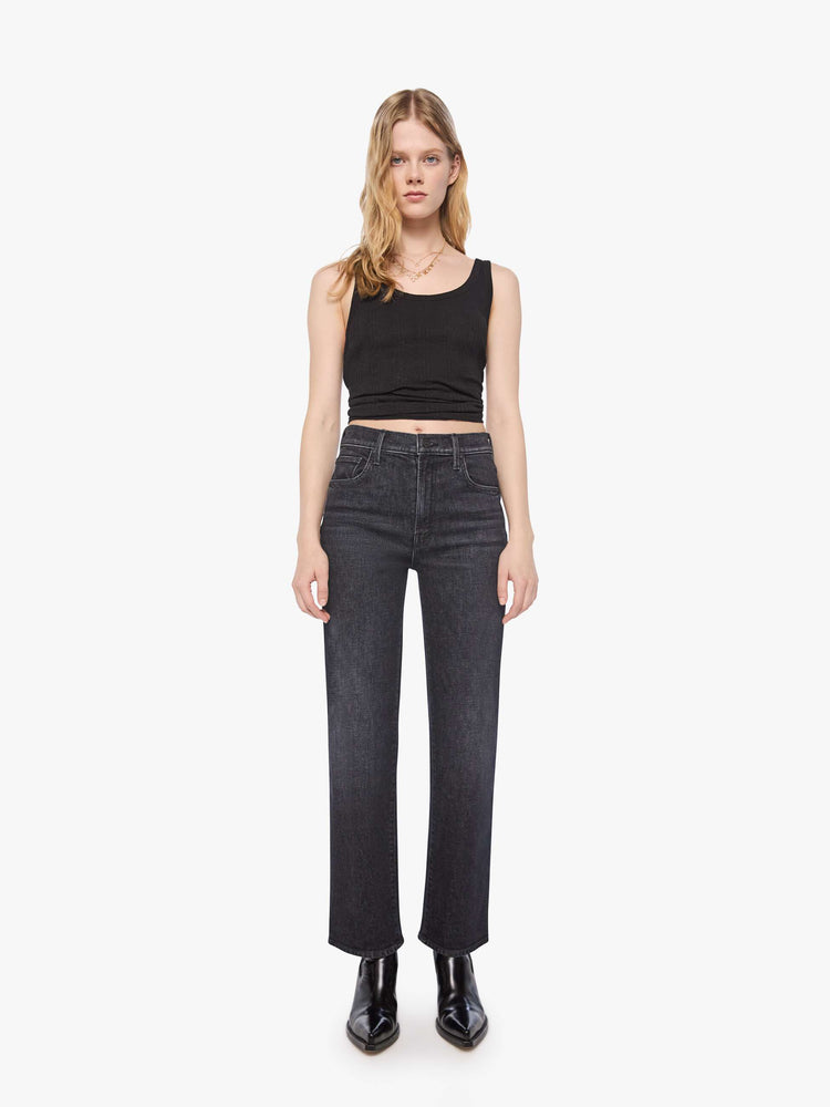 Front view of a petite woman in a washed black igh-rise jeans with a straight leg, zip fly and a 29-inch inseam with a clean hem.