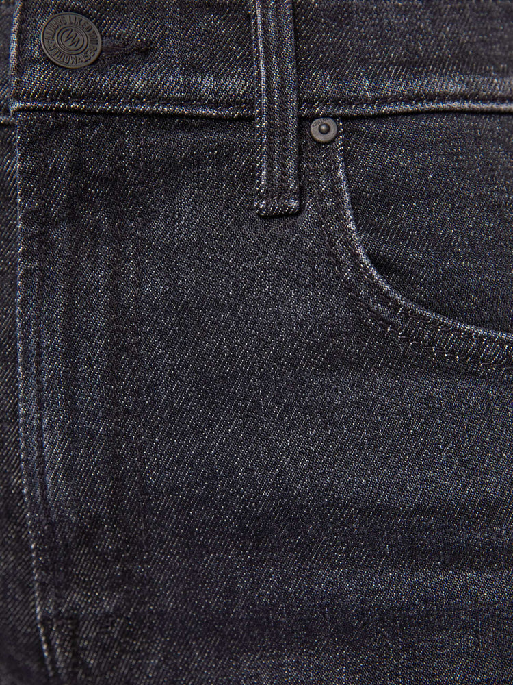 Swatch view of a petite woman in a washed black high-rise jeans with a straight leg, zip fly and a 29-inch inseam with a clean hem.