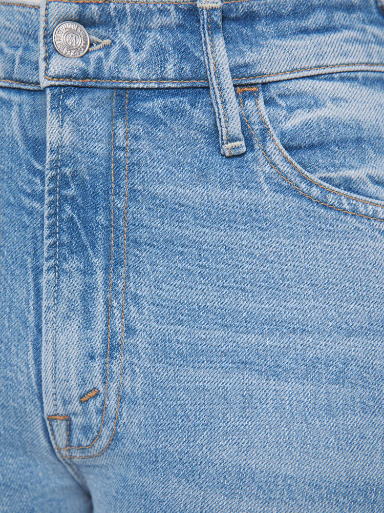 Swatch view of a woman in a light blue high-rise flare has an ankle-length inseam, zip fly and a frayed hem.