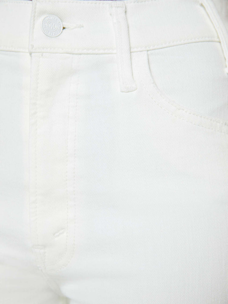 Swatch view of a woman in white high-rise flare jeans that have an ankle-length inseam and a raw hem.
