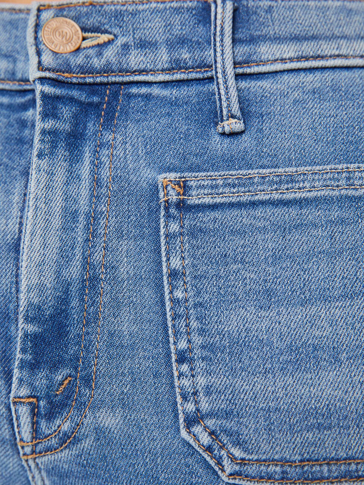 Swatch view of a petite woman flare has a mid rise, zip fly, patch pockets, a 29-inch inseam and a clean hem.