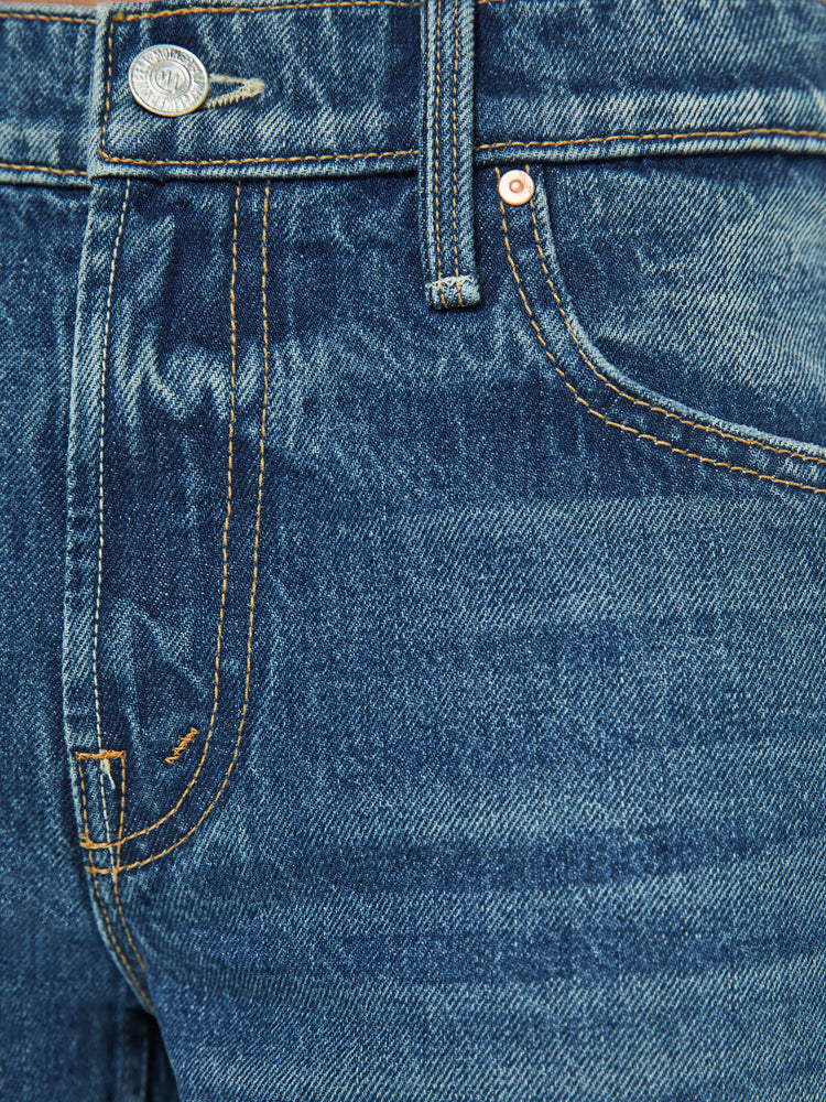 Swatch view of a petite woman in a  straight leg with a bit of a kick, the jean features a mid rise, full-length inseam and clean hem in a classic blue.
