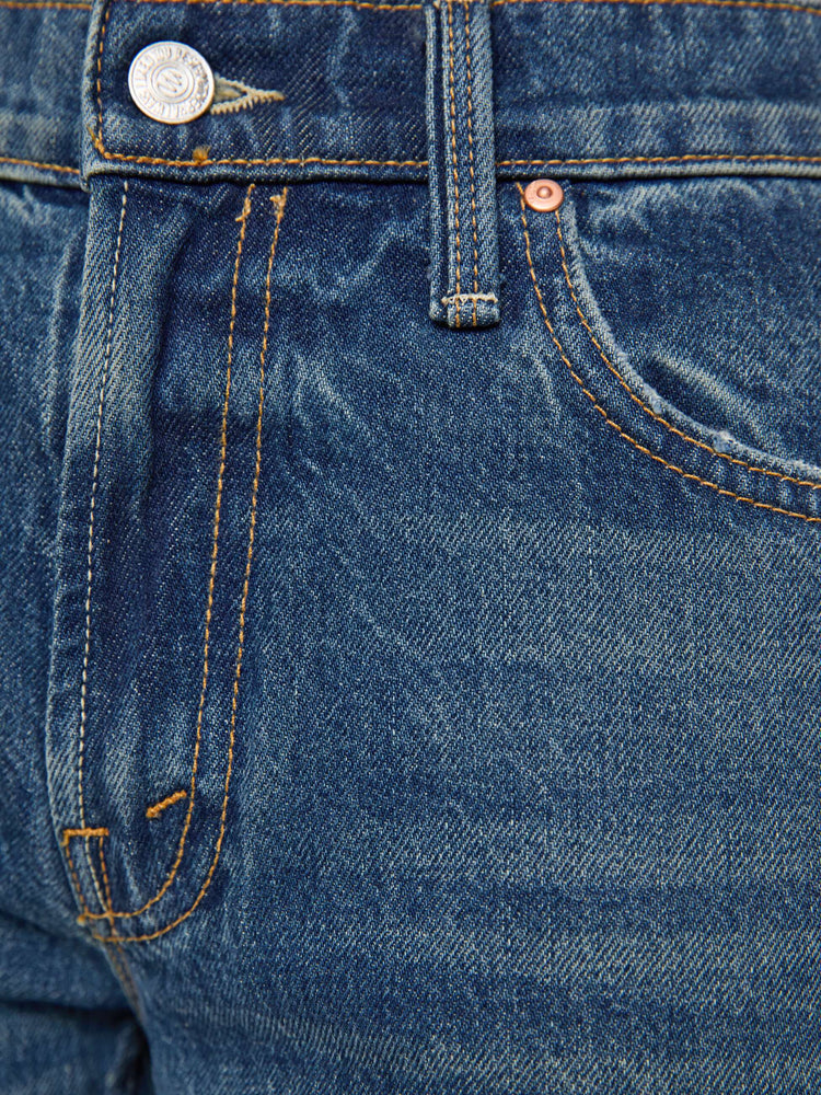 Swatch view of a petite woman in a  straight leg with a bit of a kick, the jean features a mid rise, full-length inseam and clean hem in a classic blue.