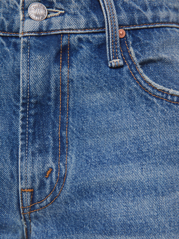 Swatch view of a petite woman in a  straight leg with a bit of a kick, the jean features a mid rise, full-length inseam and clean hem in med blue wash.