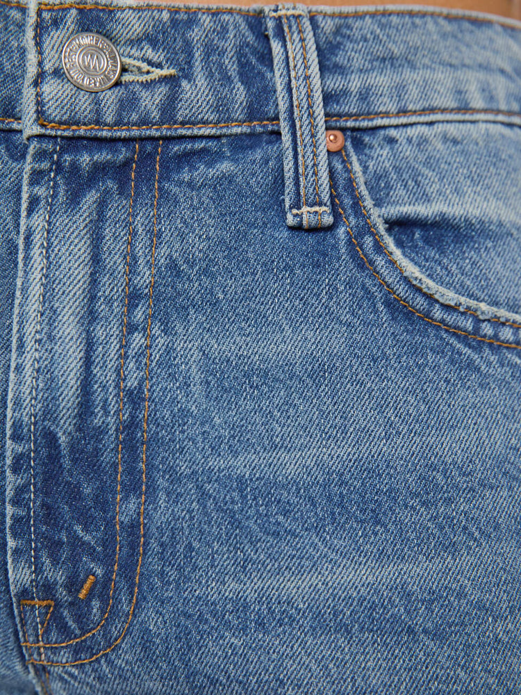 Swatch view of a petite woman in a  straight leg with a bit of a kick, the jean features a mid rise, full-length inseam and clean hem in med blue wash.