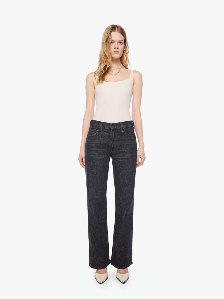 Front view of a woman in a black straight leg with a bit of a kick, the jean features a mid rise, 30-inch inseam, clean hem and relaxed fit. 
