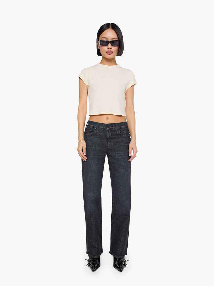 Front view of a woman in a black straight leg with a bit of a kick, the jean features a mid rise, 30-inch inseam, clean hem and relaxed fit. 