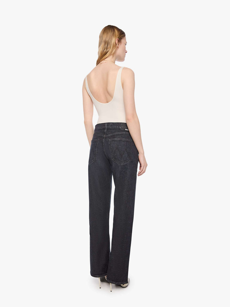 Back view of a woman in a black straight leg with a bit of a kick, the jean features a mid rise, 30-inch inseam, clean hem and relaxed fit. 
