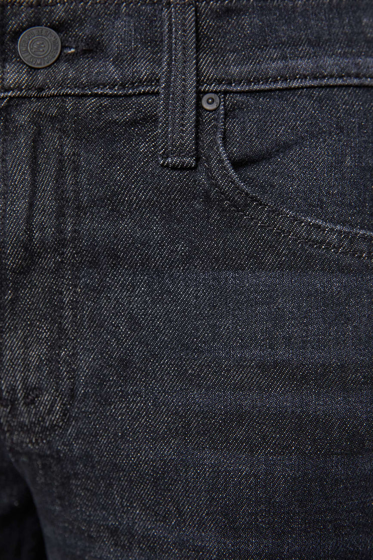 Swatch view of a woman in a black straight leg with a bit of a kick, the jean features a mid rise, 30-inch inseam, clean hem and relaxed fit. 