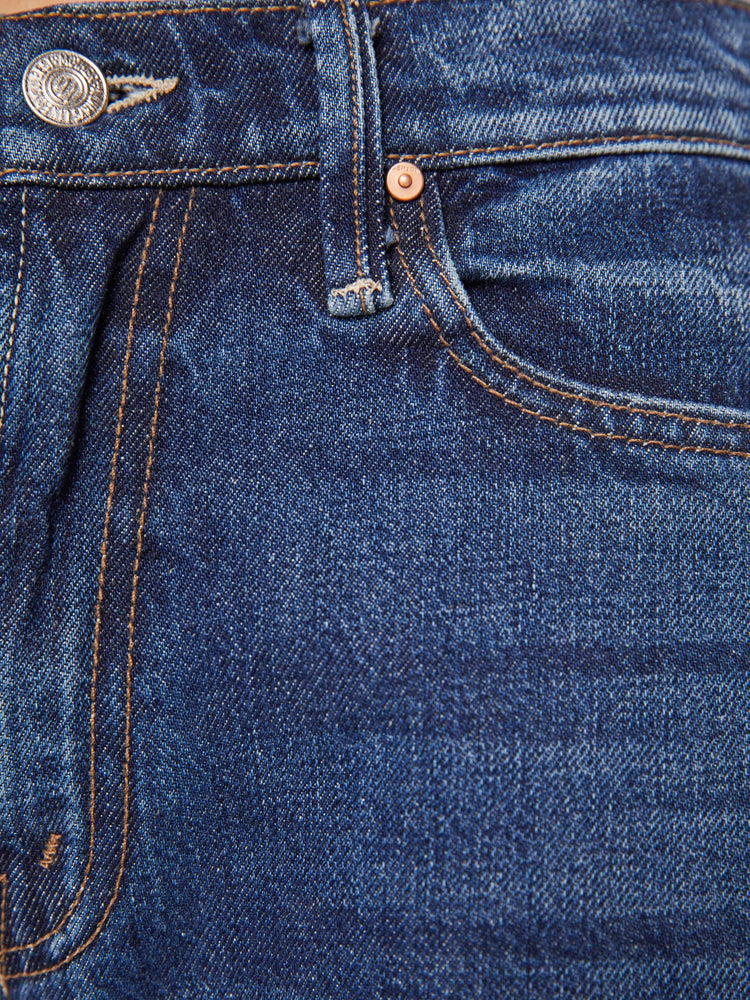 Swatch view of a petite woman in a mid-rise jeans designed to sit lower on the hips with a full barrel leg, zip fly, 26.25-inch inseam and a frayed hem.