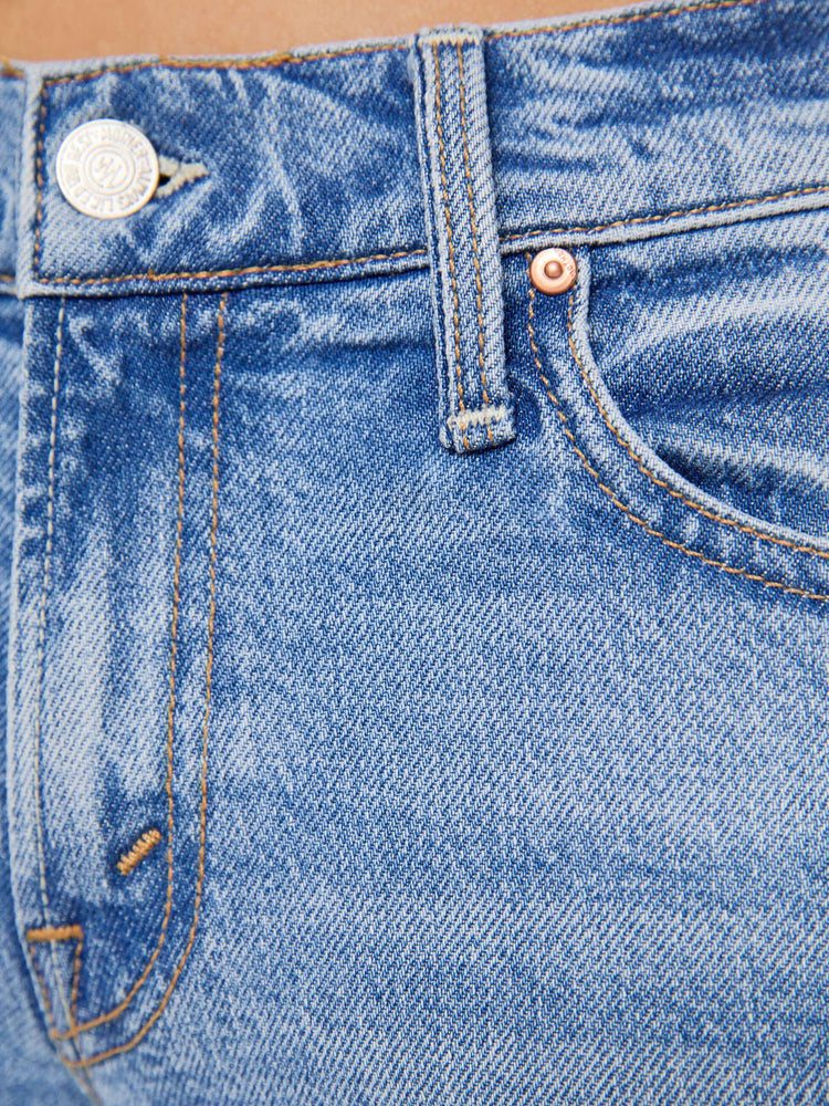 Back close up  view of a petites woman in a light blue lower-rise bootcut jean with a zip fly, long 29-inch inseam and a clean hem.