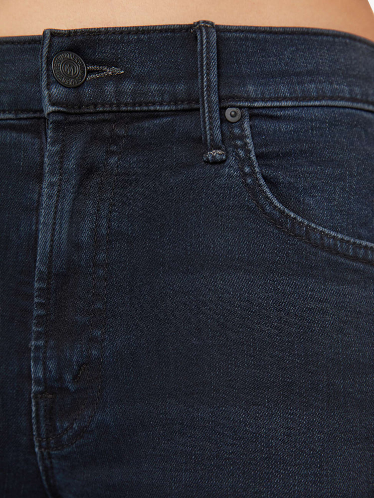 Swatch view of a petite woman high-waisted bootcut hits at the ankle with a frayed step-hem dark denim jean.