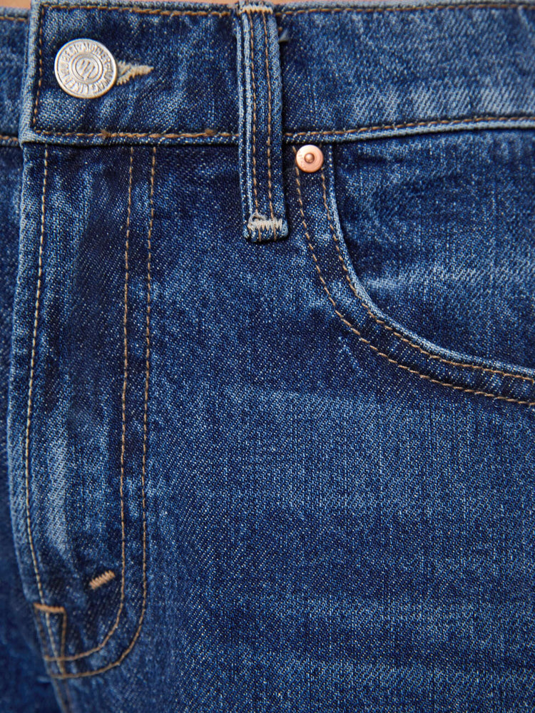 Swacth view of a petite woman in a mid-rise bootcut with a zip fly, looser leg, twisted outer seam and a long 32-inch inseam with a clean hem.