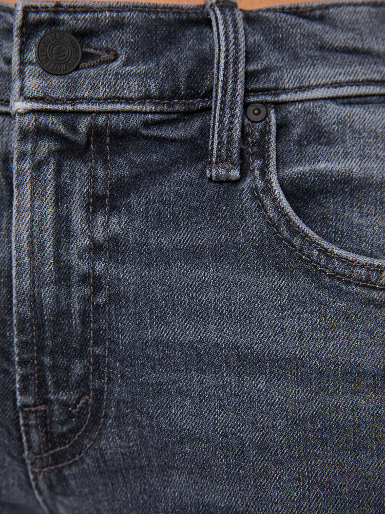Swatch view of a woman in a washed grey mid-rise bootcut with a zip fly, looser leg, twisted outer seam and a long 29-inch inseam with a clean hem.