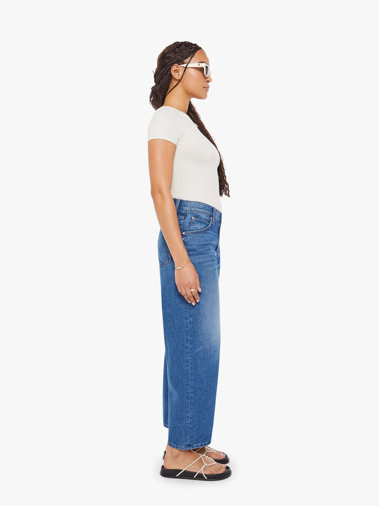 Side  view of a woman in Jeans designed to sit lower on the hips with a 28-inch inseam, zip fly, clean hem and slightly tapered leg. 