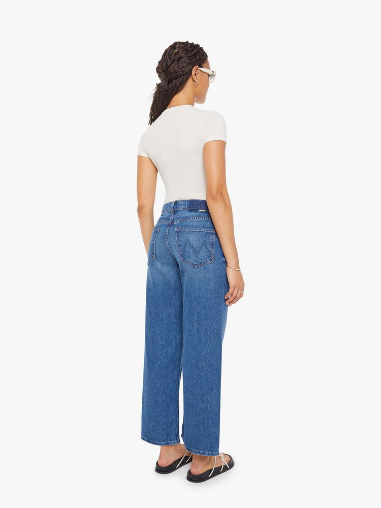 Back  view of a woman in Jeans designed to sit lower on the hips with a 28-inch inseam, zip fly, clean hem and slightly tapered leg. 