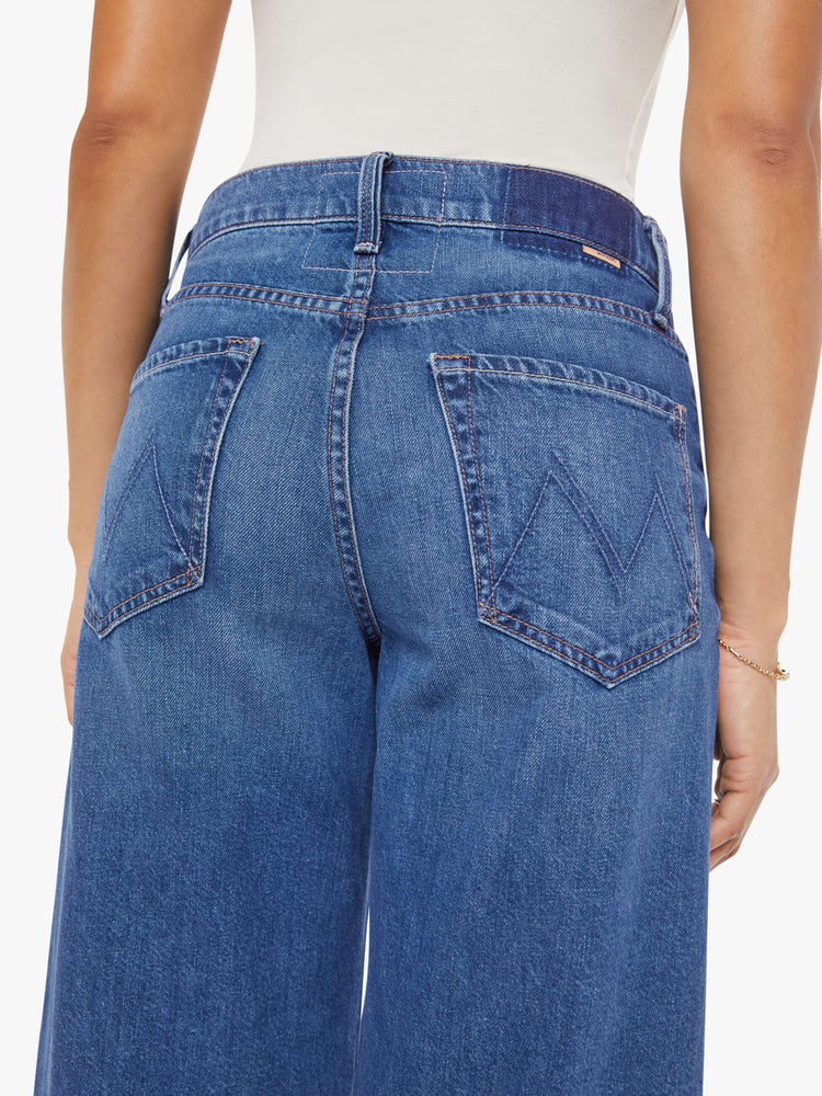 Back  view of a woman in Jeans designed to sit lower on the hips with a 28-inch inseam, zip fly, clean hem and slightly tapered leg. 