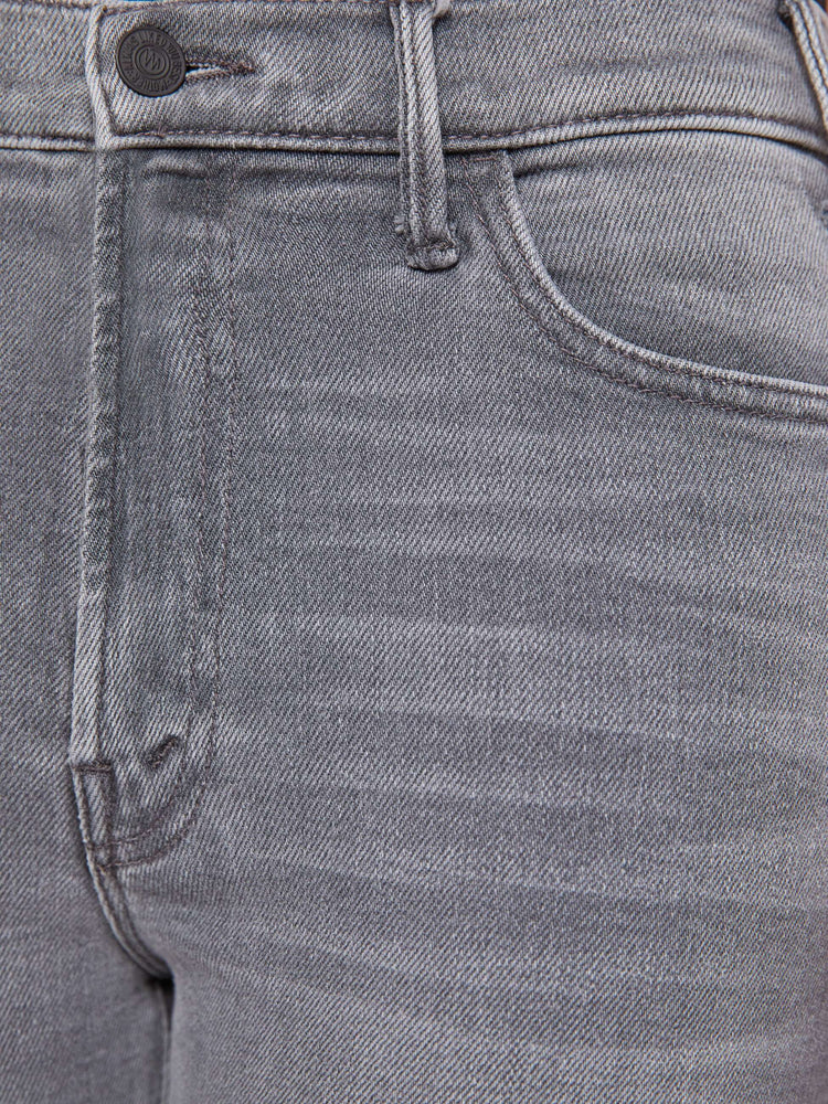 Swatch view of a petite woman in a grey high-rise flare has a zip fly, ankle-length inseam and a clean hem.