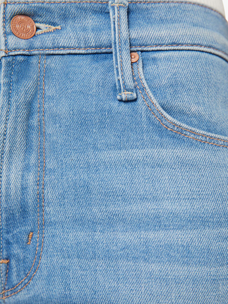 Swatch view of a woman in a light blue  high-rise flare with a zip fly, long 30-inch inseam and a clean hem. 